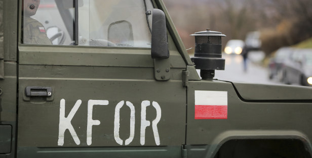 Polish soldiers, part of NATO peacekeeping mission in Kosovo (KFOR), are parked by the side of a road blocked with heavy vehicles in the village of Rudare, northern Kosovo.