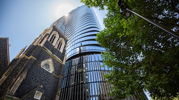 Wesley Place towers over a historic church on Lonsdale Street.