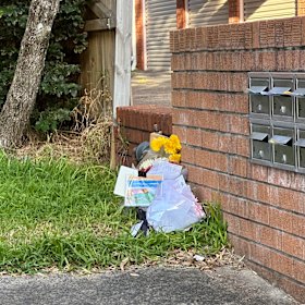 Mourners left flower tributes and notes outside the Randwick apartment building.