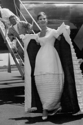 Diane Masters models the  gown of the year at Mascot airport in 1959.
