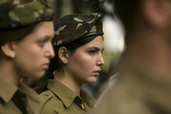 An Israeli soldier stands in an honor guard ceremony during the funeral of an Israeli soldier killed in southern Gaza.