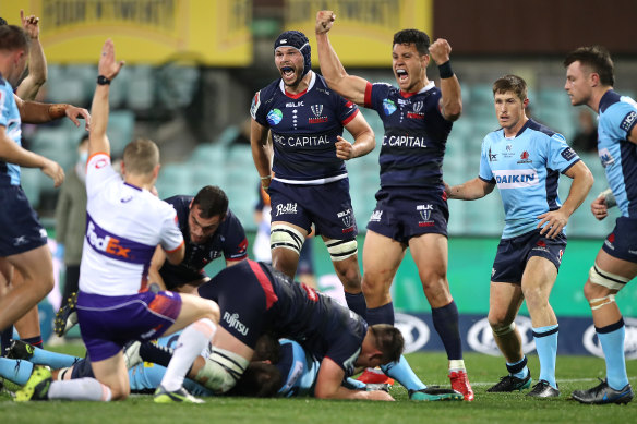 Matt Toomua (third from right) celebrates a try by Rebels teammate Ryan Louwrens on Friday night.