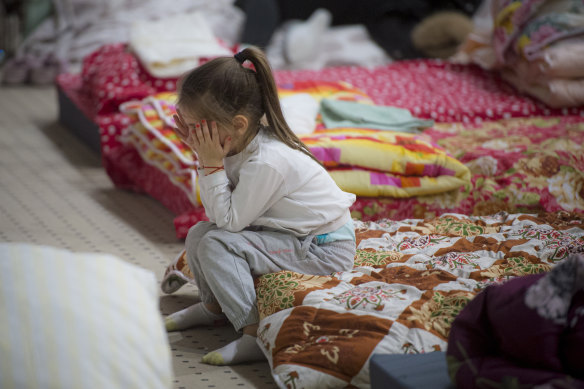 A refugee who fled the conflict from neighbouring Ukraine in the event hall of a hotel in Siret, Romania.