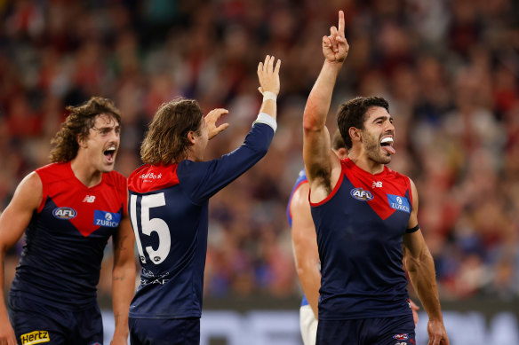 Christian Petracca and the Demons celebrate a goal en route to victory.