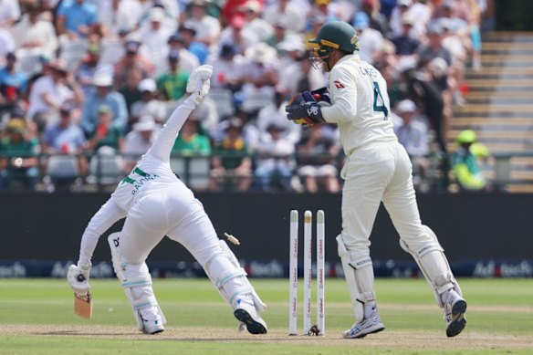 South Africa’s captain Temba Bavuma, left, is bowled out by Nathan Lyon.