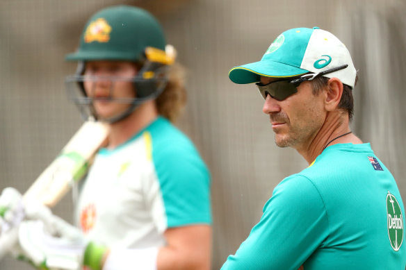 Justin Langer watches on as Will Pucovski trains in the nets.