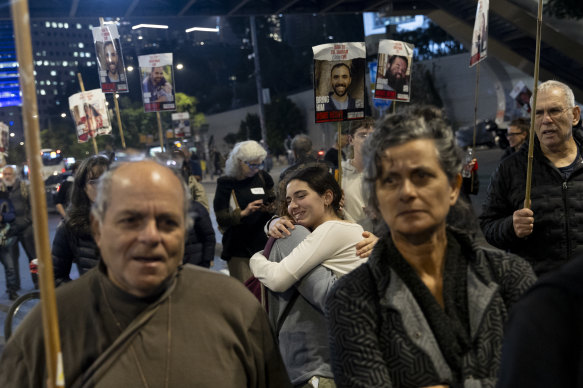 Protesters calling for the return of hostages held in the Gaza Strip react after a Gaza ceasefire and hostage release deal in Tel Aviv.