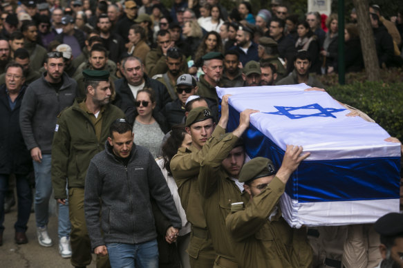 Family and friends mourn as they walk behind the coffin during the funeral of a soldier killed in a battle in south Gaza.