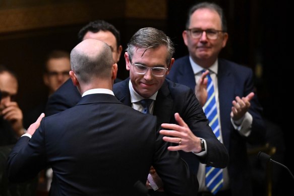 NSW Premier Dominic Perrottet hugs Treasurer Matt Kean after his budget address on Tuesday.