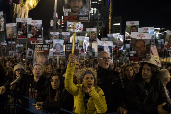 A protest in Tel Aviv where people hold signs and photos of hostages, calling for their release. 