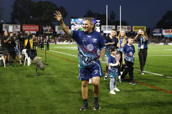 Royce Simmons enters BlueBet Stadium before the match following his 300km walk for dementia awareness.
