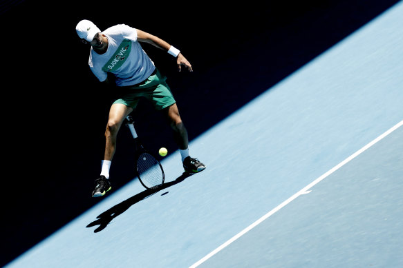 Novak Djokovic plays a ‘tweener’ during a practice session at Melbourne Park on Sunday.