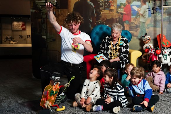 Tom Hetherington-Welch and Rebecca Hetherington entertain children at the National Museum of Australia on Thursday.