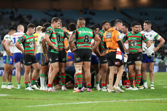 Players gather around Corey Harawira-Naera as he receives medical attention.