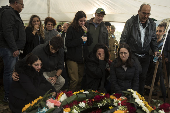 Family and friends mourn Captain (res) Nir Binyamin at his funeral in Kfar Vitkin, Israel, on Tuesday. He was killed in a battle in South Gaza.