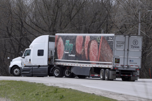 A truck turns onto a highway after leaving the Tyson Foods pork plant in Perry, Iowa.