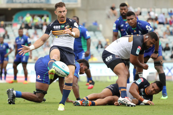 Nic White of the Brumbies kicks the ball.