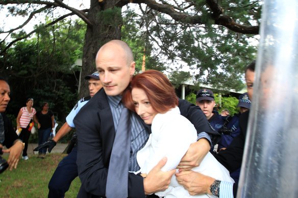  Julia Gillard is dragged away after hundreds of protesters from the Aboriginal Tent Embassy descended on the awards ceremony she was at a few hundred metres away in 2012.