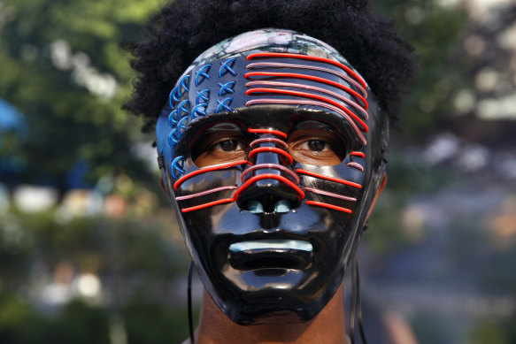 Darius Scott, 17, of Germantown, Maryland, wears a mask he designed and made himself at a protest on a street that's been renamed Black Lives Matter Plaza.