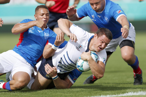 Namibian players bring down Italy’s Luca Morisi during their Rugby World Cup Pool B game in Osaka on Sunday.