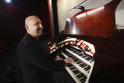 Scott Harrison, president of the Victorian division of the Theatre Organ Society of Australia, with “Eliza” at Dendy Cinemas in Brighton.