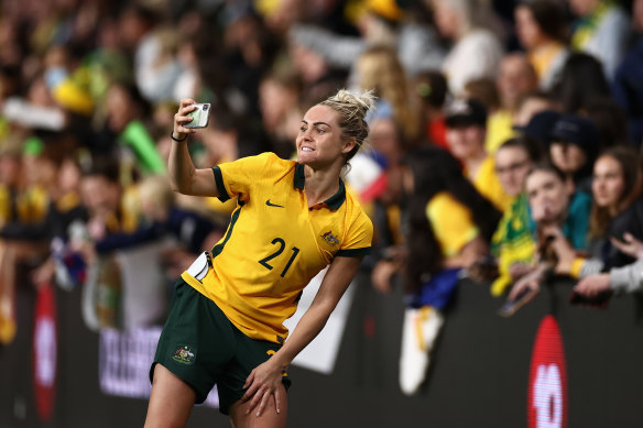 Ellie Carpenter of the Matildas poses with fans after the friendly against Brazil in Sydney last month.