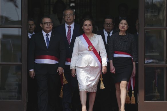 Peruvian President Dina Boluarte (centre) and newly named cabinet members gather after their swearing-in ceremony at the government palace in Lima on December 10.