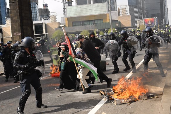 Fires burn during anti-war protests in Melbourne.