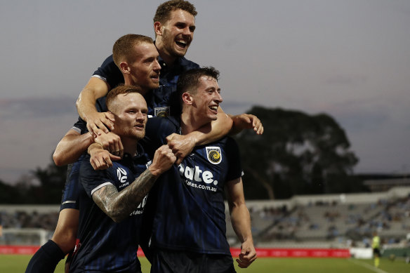 The Mariners celebrate their opening goal against Sydney FC. 