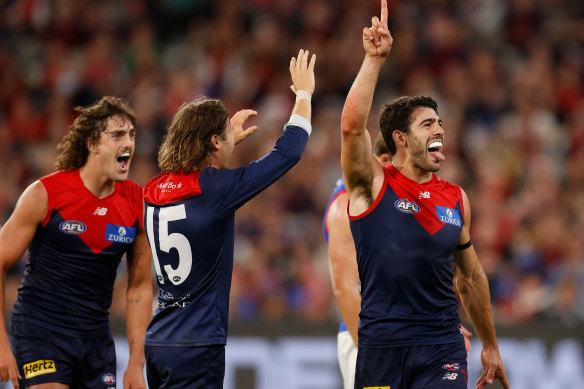 Christian Petracca and the Demons celebrate a goal en route to victory.