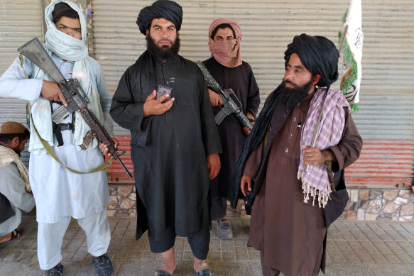 Taliban fighters patrol inside the city of Farah, south-west of Kabul, on Wednesday.