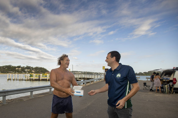 Bundeena resident Stuart Buman picks up RAT tests for his children  Eve and Dane.
