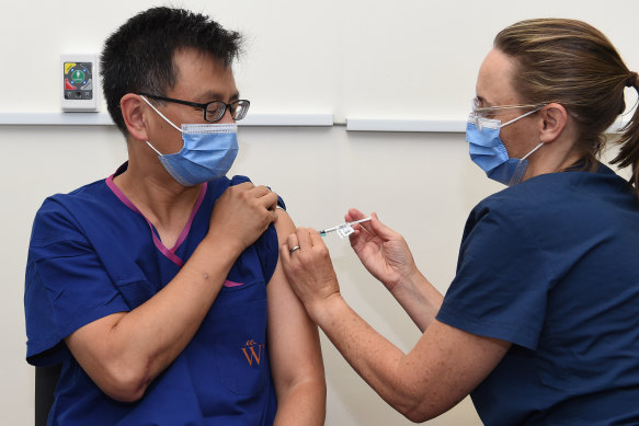 Professor Allen Cheng receives the Pfizer jab at The Alfred hospital on Friday morning.