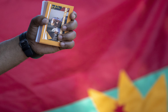 A member of the Tigrayan-Ethiopian community in Pretoria, South Africa, holds a booklet titled "Nobel Prize Licence to Kill" during a protest against the conflict in Ethiopia's Tigray region.