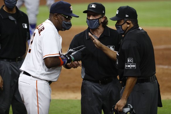 Astros manager Dusty Baker chats with the umpires after the benches cleared.