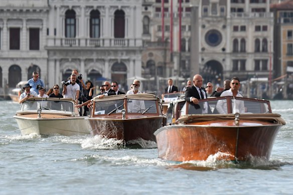 A flotilla of boats in Venice travel past St Mark’s Square before the wedding.