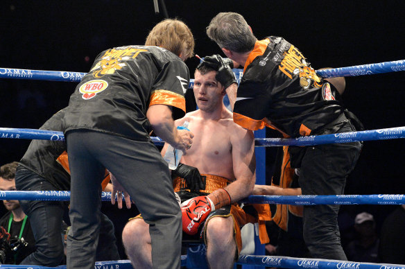 Jeff Horn receives attention from his team during rounds.