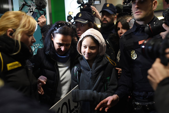 Thunberg was surrounded by supporters and police after arriving in Spain by train from Lisbon.