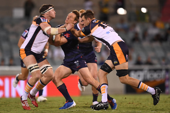 The Rebels' Dane Haylett-Petty is wrapped up by the Brumbies defence on Friday night.
