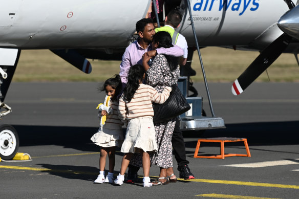 Priya and Nades Murugappan and their daughters Kopika and Tharnicaa hug as they arrive at the Thangool Aerodrome near Biloela. Four years ago, the Murugappan family were removed from their home in central Queensland by the Australian Border Force and taken to immigration detention.
