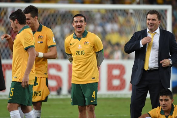 Tim Cahill and Ange Postecoglou soak in the Socceroos’ Asian Cup triumph in 2015.