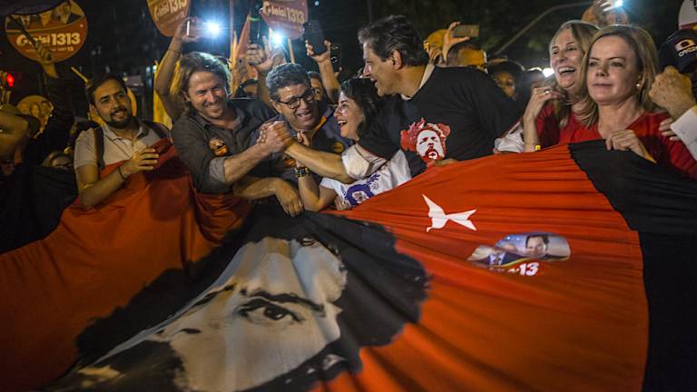 Fernando Haddad, former mayor of Sao Paulo, third right, and Senator Gleisi Hoffman, president of the Workers' Party, right, join demonstrators in support of Lula on Thursday.