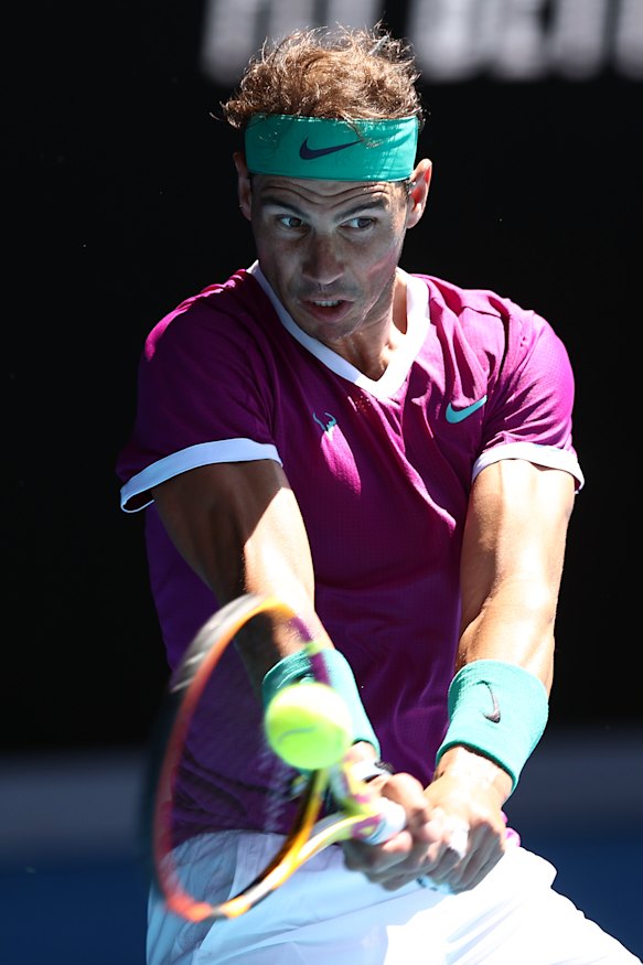 Rafael Nadal plays a backhand.