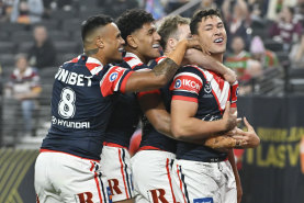The Roosters celebrate Joey Manu’s try against the Broncos.