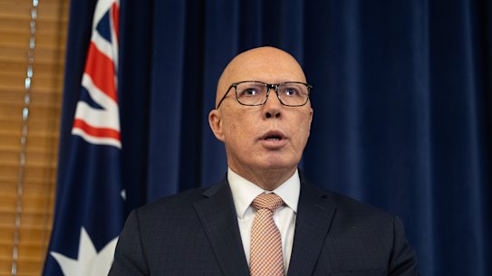 Opposition Leader Peter Dutton during a press conference in July, flanked by the Australian flag.