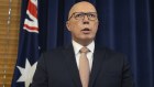 Opposition Leader Peter Dutton during a press conference in July, flanked by the Australian flag.