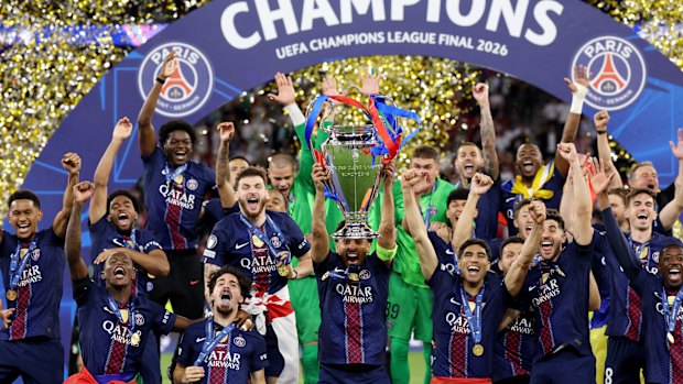 PSG players celebrate with the trophy after winning the Champions League final in Budapest.