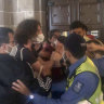 Protesters storm Liberal-aligned exhibition opening at Melbourne University