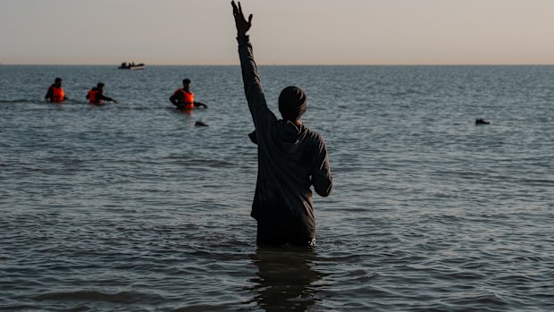 A man gestures as he waits to board a migrant dinghy to sail into the English Channel on June 17, 2025 in Gravelines, France. A record number of migrants have made the illegal crossing from France to the UK via small boats so far this year. Figures surpassed the 16,000 mark last week, which is 42% more than the same point last year.