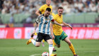 Lionel Messi controls the ball against Kye Rowles.